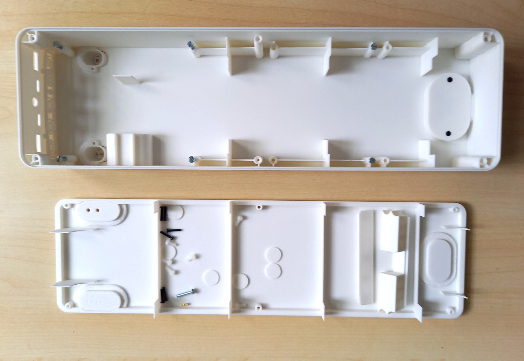 The enclosure opened into its two halves, showing internal mounting structure